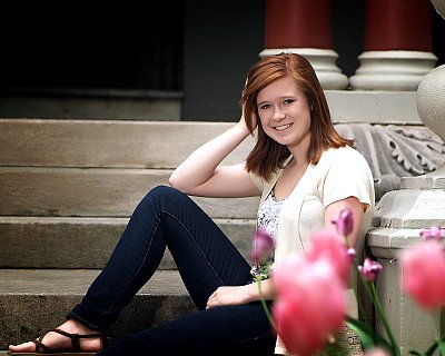 senior picture of louisville kentucky graduate. Girl with red hair sitting on white staircase