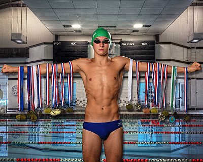 senior picture of louisville kentucky graduate. boy swimmer in swimsuit holding out swimming metals with a pool in the background